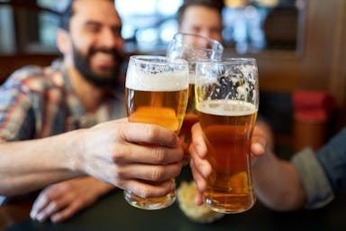 happy male friends drinking beer at bar or pub | Image Credit: © Syda Productions - stock.adobe.com