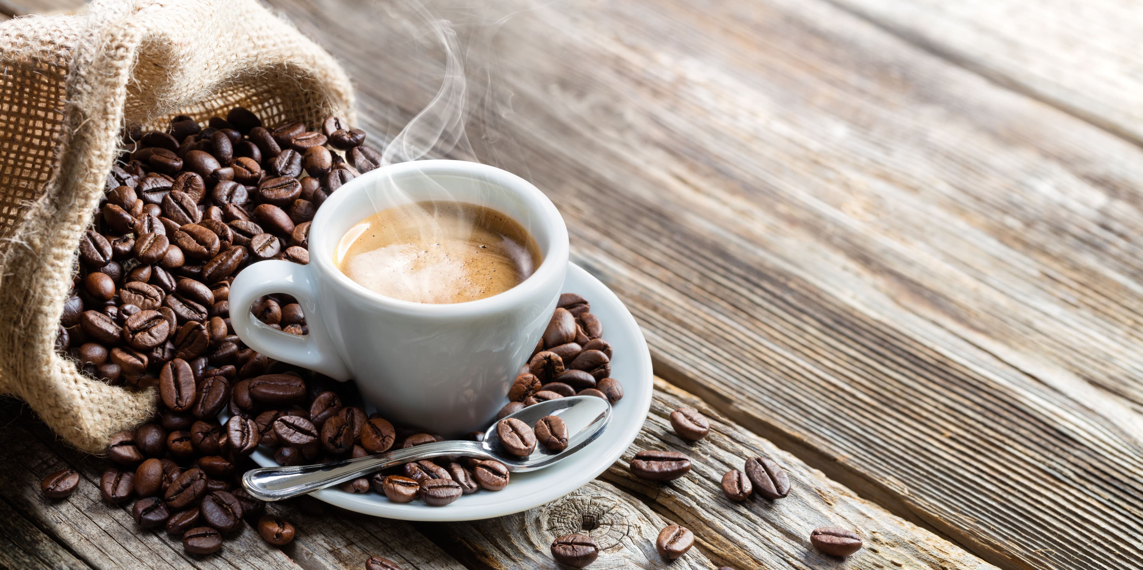 Espresso Coffee Cup With Beans On Vintage Table | Image Credit: © Romolo Tavani - stock.adobe.com