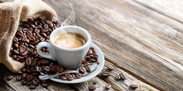 Espresso Coffee Cup With Beans On Vintage Table | Image Credit: © Romolo Tavani - stock.adobe.com