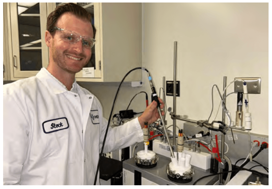 Smith working on a Raman microscope to develop data-rich technologies that enable process research & development efforts, including elucidating immobilized enzymes for biocatalysis and studying virus-like particles for vaccine applications. (Courtesy of Joseph P. Smith, 2024).