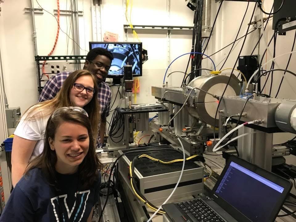 Members of the Eigenbrodt Research Laboratory (Darnell Pierre “G”, Emily Legaard “UG”, and Marissa Bradley “UG”) conducting research at Advanced Photon Source at Argonne National Laboratory located in Lemont, IL. This research was supported through Argonne National Laboratory (GUP-58314). Specifically, research was conducted at the 10-BM beamline to explore and understand the chemistry occurring inside fuel cell devices. | Photo Credit: © Bryan Eigenbrodt
