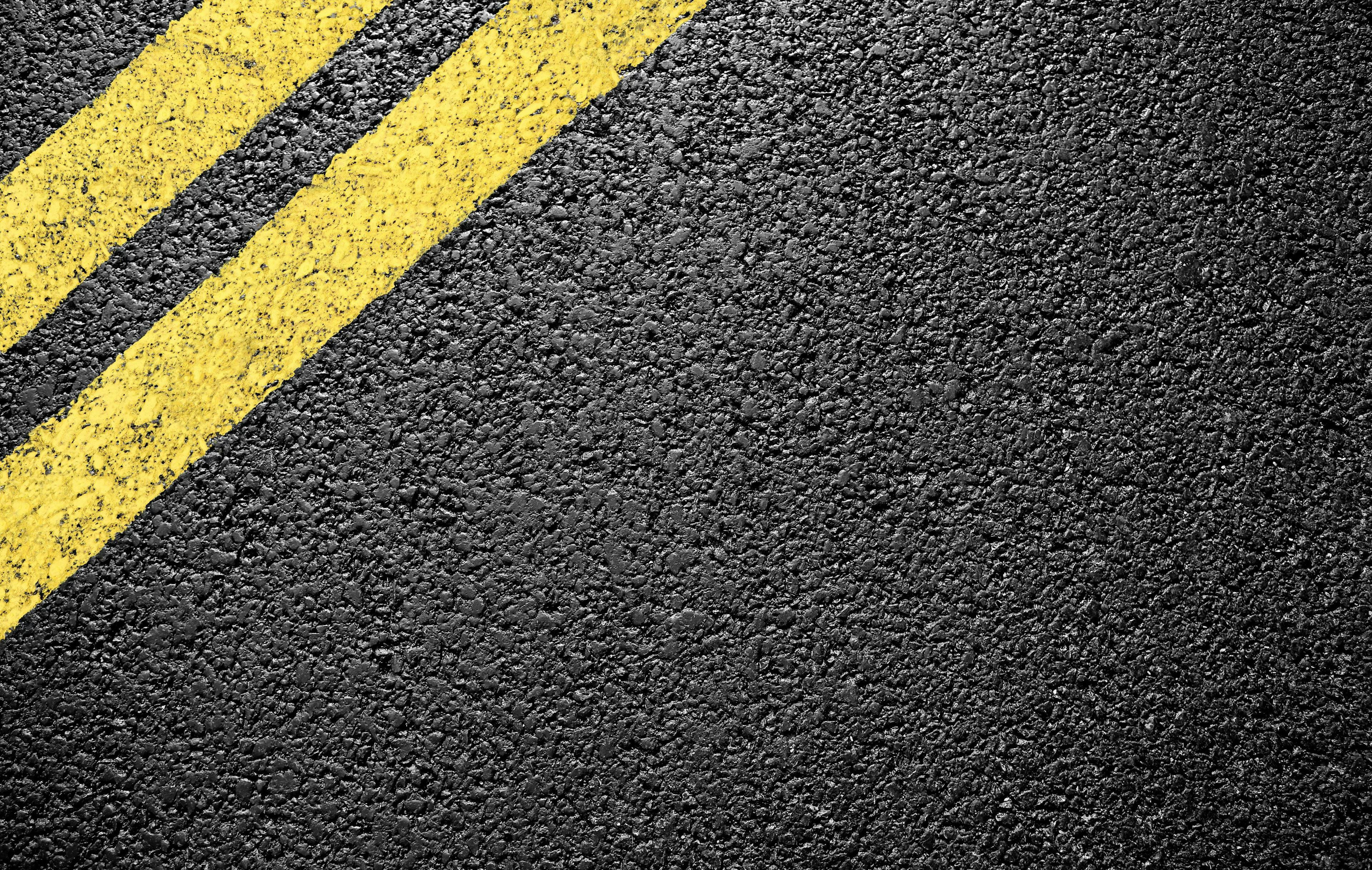 black asphalt yellow markings | Image Credit: © Vitaly Krivosheev - stock.adobe.com